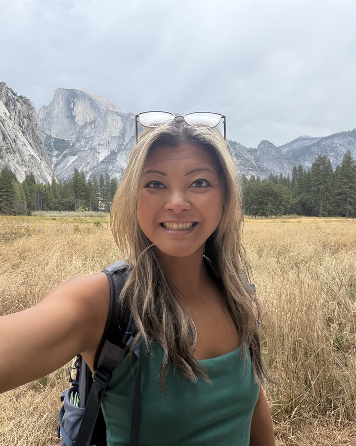 Lily Adams smiling in a mountain meadow
